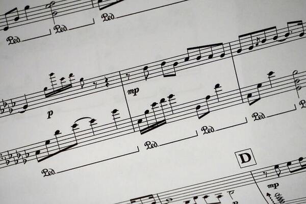 Rhythmic lyrics translation: Customizing a pre-trained language model using stacked fine-tuning