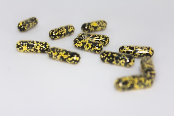 The Effect of Bead Shape and Texture on the Energy Loss Characteristics in a Rotating Capsule